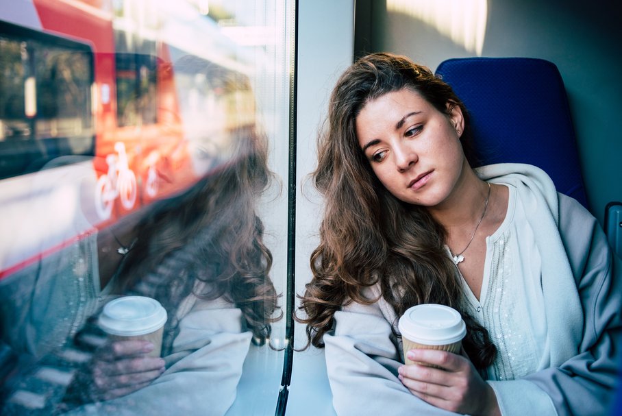 Smutna młoda kobieta w pociągu.
